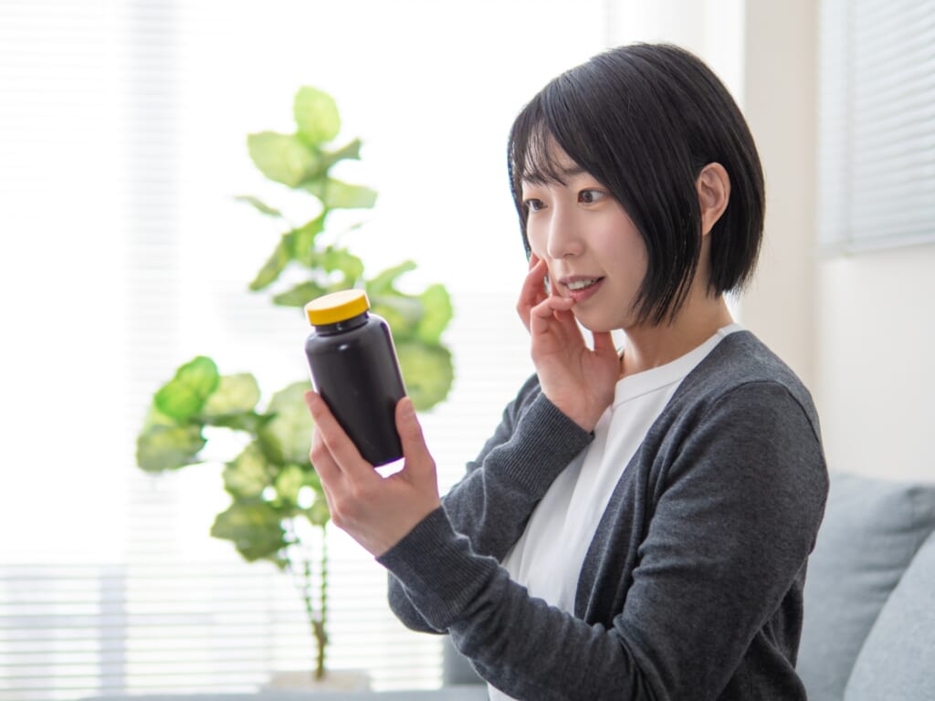 サプリの表示を確認する女性